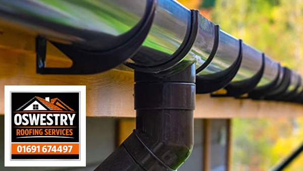 Oswestry Roofing Services Black half-round gutter, brackets and downpipe outlet