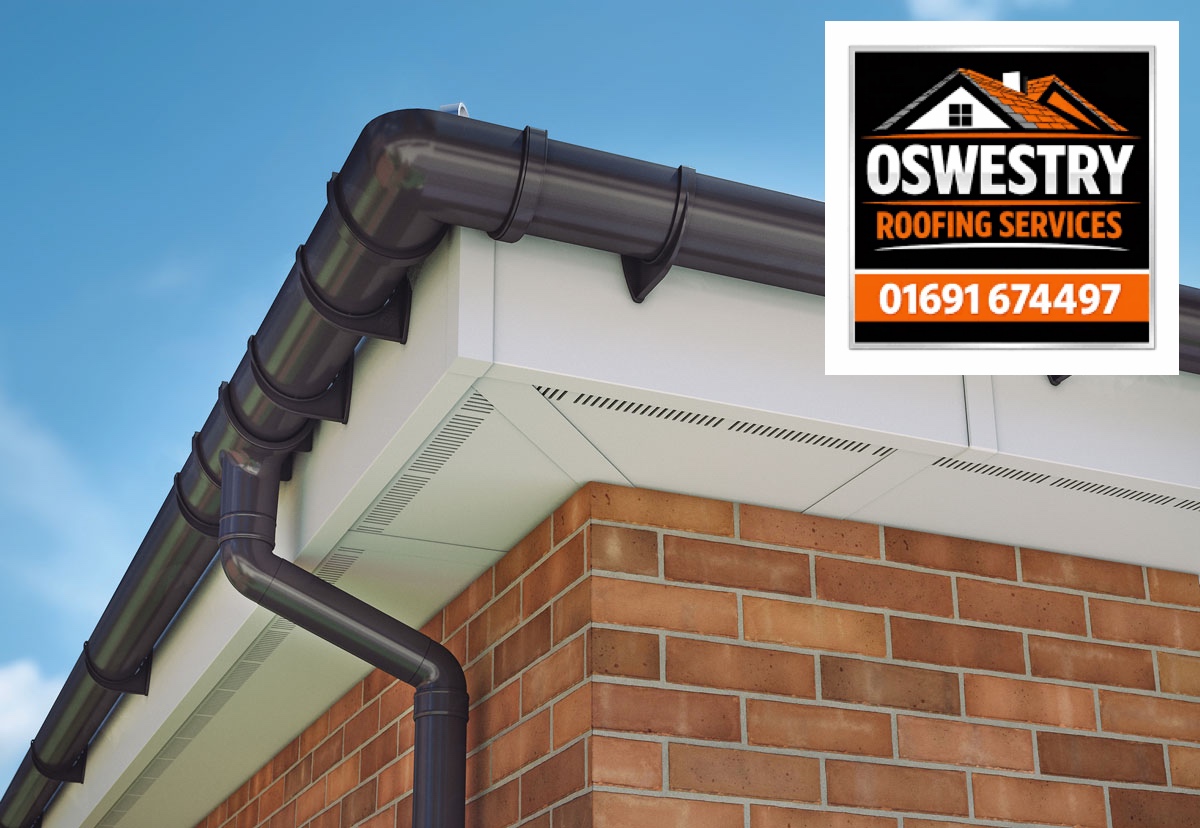 Oswestry Roofing Services Dark guttering and downpipe with white fascia and soffits