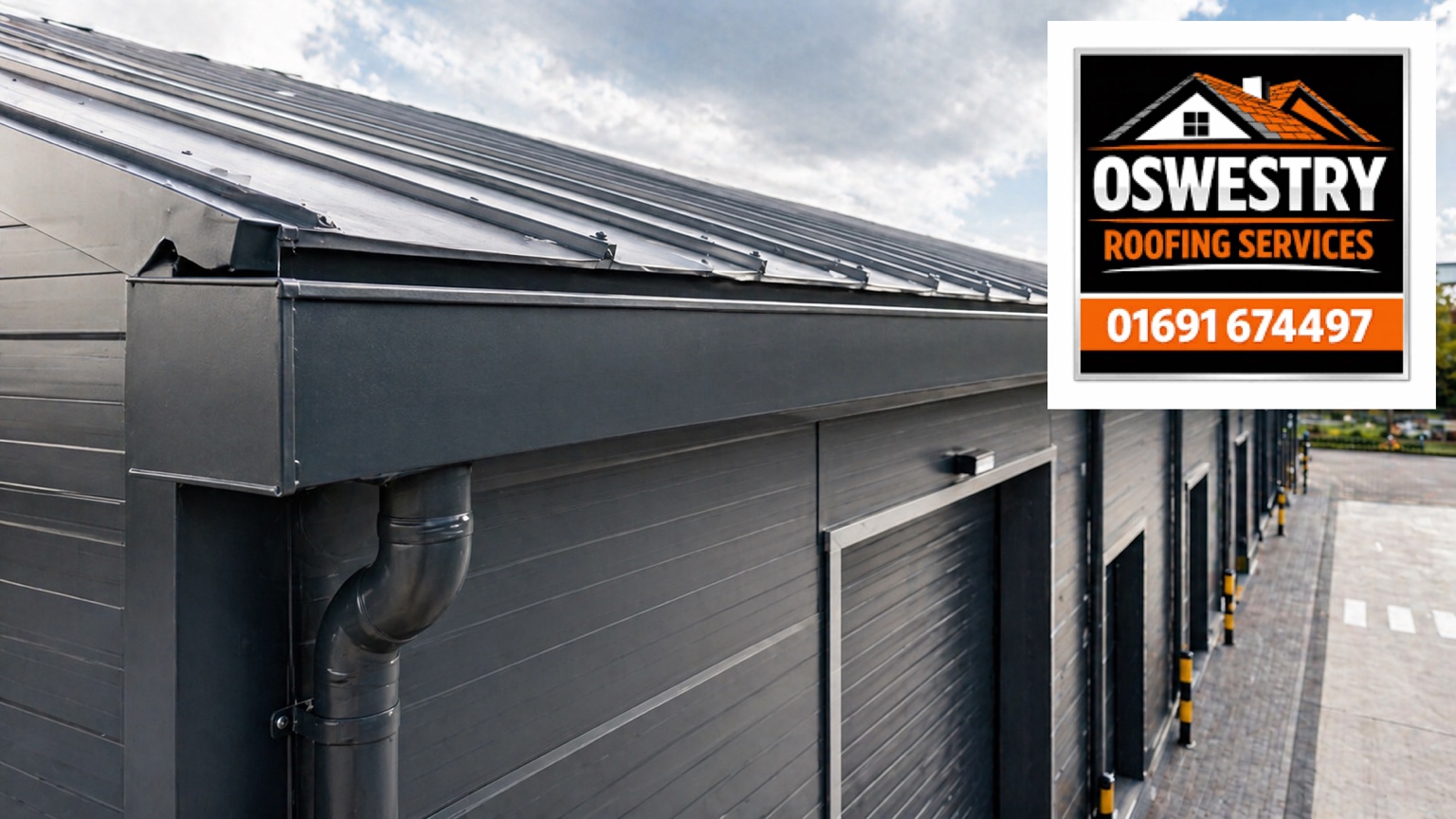 Oswestry Roofing Services Box gutter and downpipe on a commercial building