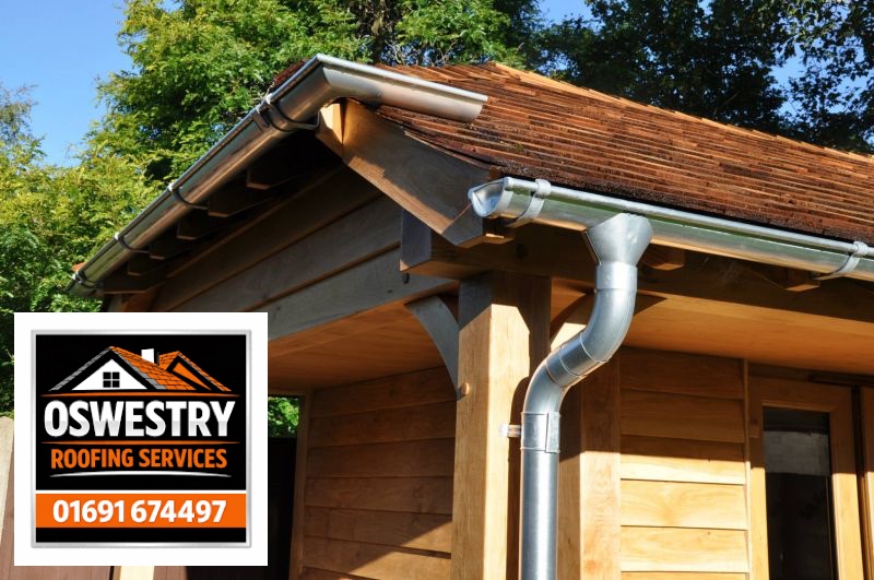 Oswestry Roofing Services Metal gutters and downpipe on a timber building
