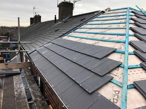 Oswestry Roofing Services Natural slates being laid in straight courses over breathable membrane and timber battens for roofing work in Oswestry