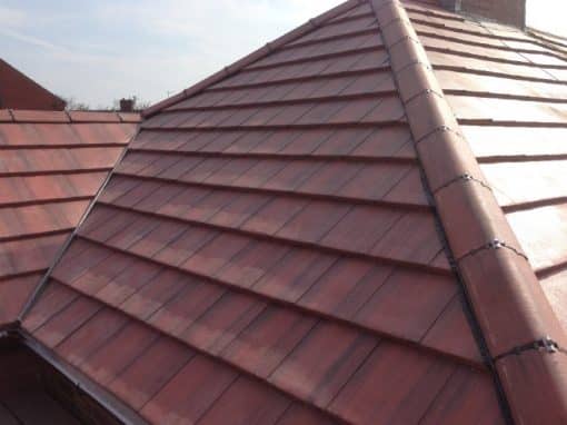 Oswestry Roofing Services Completed red tiled hip roof with secure ridge and hip tiles for roofing work in Oswestry