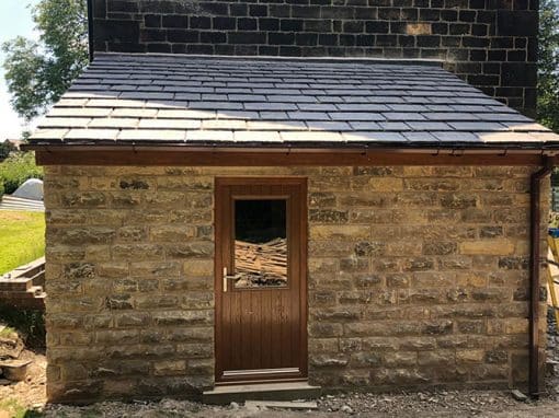 Oswestry Roofing Services New natural slate lean-to roof installed on a stone outbuilding for roofing work in Oswestry