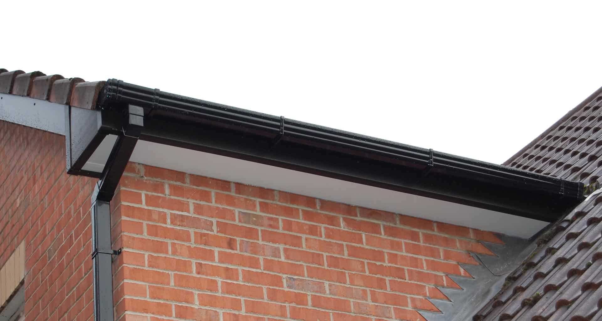 Oswestry Roofing Services New fascia boards, soffits and black guttering fitted neatly to a residential roofline in Oswestry